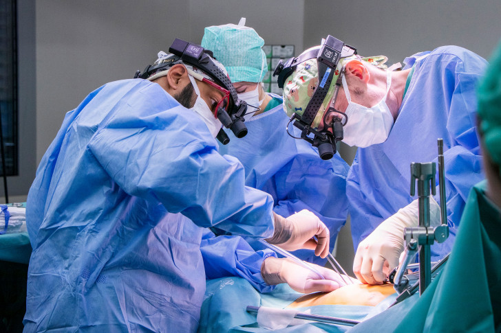 Zwei Chirurgen Sasha Tharakan und Ueli Möhrlen operieren ein Kind