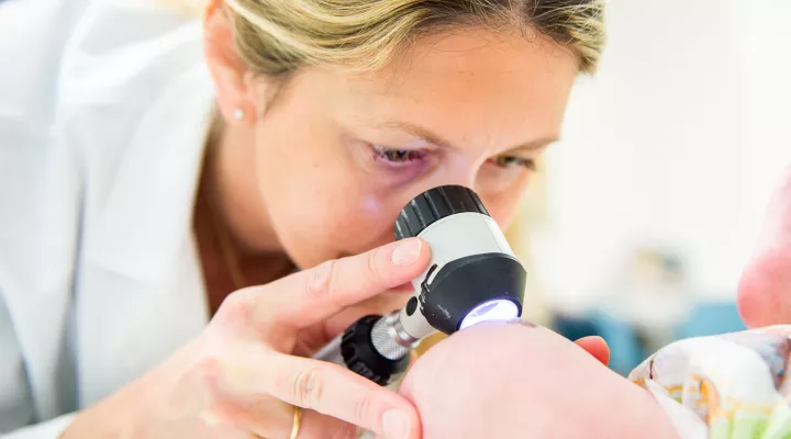 Die Dermatologin Lisa Weibel untersucht die Haut eines Babys