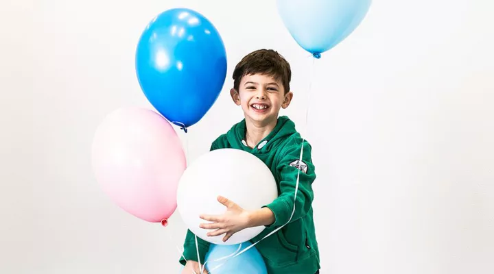 Kind mit Luftballonen Jubiläum Kinderspital