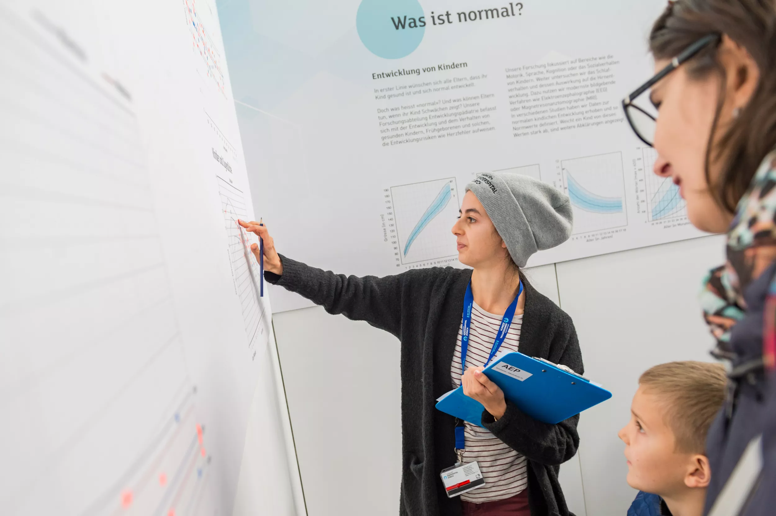 Kispi Mitarbeiterin gibt Besuchenden Informationen 